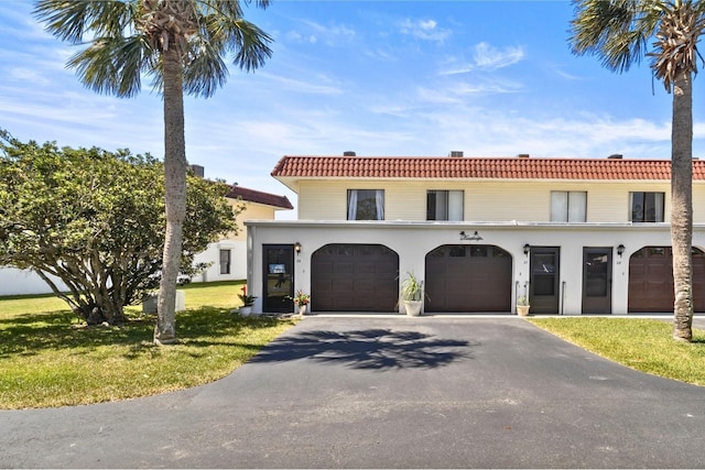 26 Ocean Palm Villa S Unit 26, Flagler Beach, FL 32136 - mediterranean / spanish-style home featuring a tile roof, a front lawn, a garage, stucco siding, and driveway