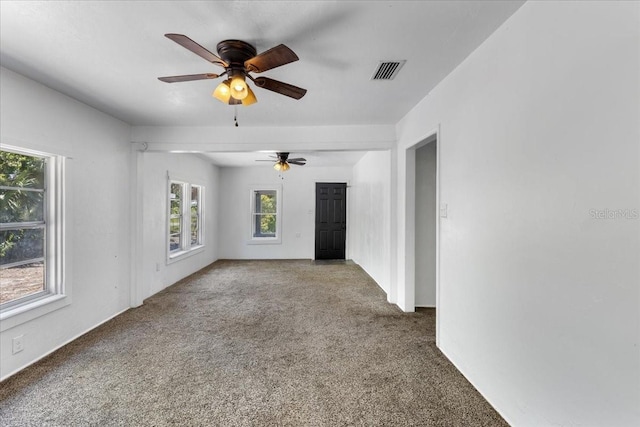 unfurnished room with ceiling fan, visible vents, and carpet floors