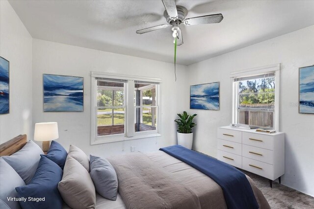 carpeted bedroom featuring ceiling fan