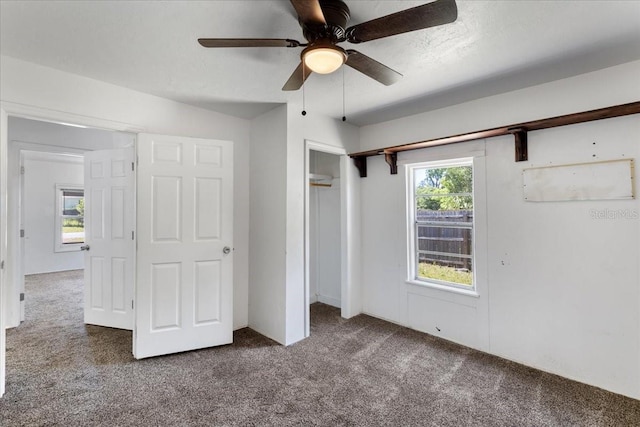 unfurnished bedroom with a ceiling fan, carpet, a closet, and a textured ceiling