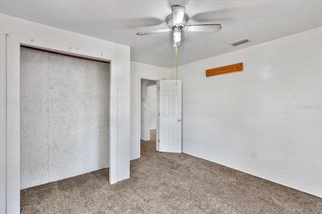 unfurnished bedroom with a ceiling fan, carpet, a closet, and visible vents