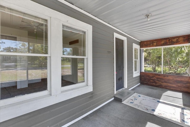 unfurnished sunroom featuring a ceiling fan