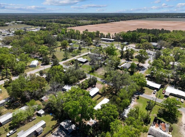 drone / aerial view with a wooded view