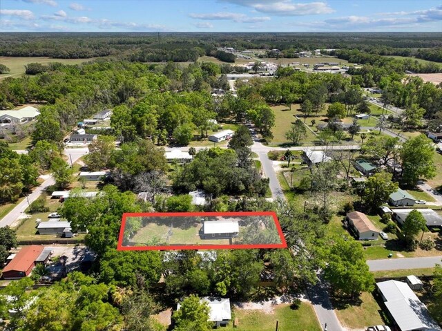 birds eye view of property with a wooded view