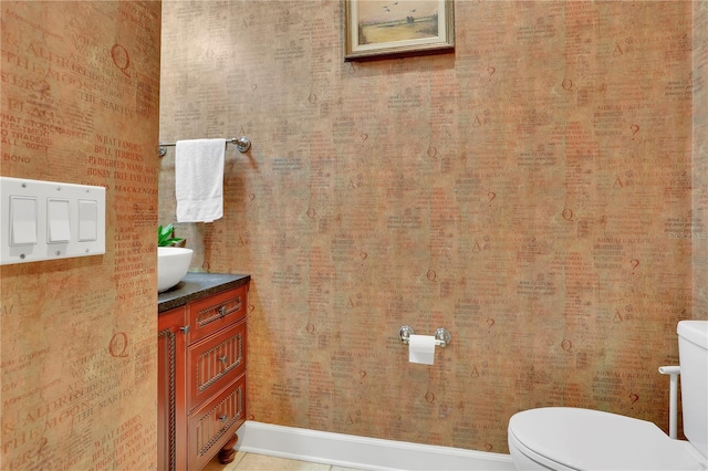 half bath featuring toilet and vanity