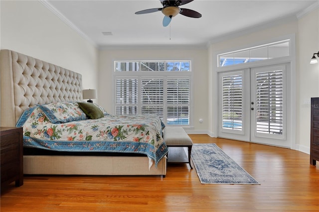 bedroom with ornamental molding, baseboards, access to exterior, and wood finished floors