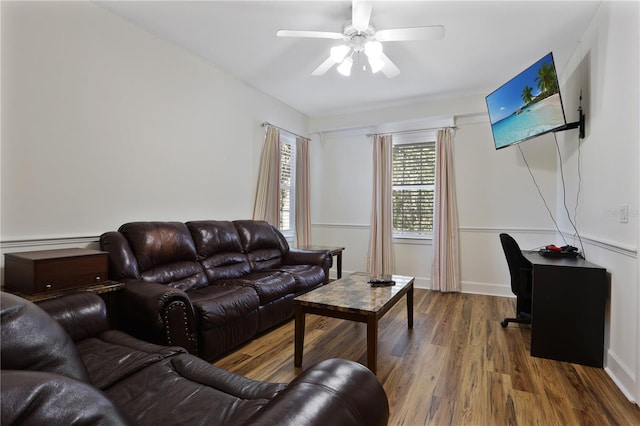 living area featuring wood finished floors and a ceiling fan