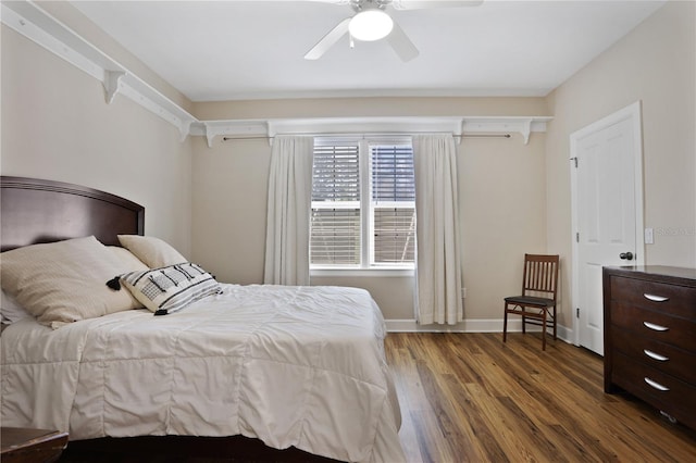 bedroom featuring baseboards, ceiling fan, wood finished floors, and a wall mounted air conditioner