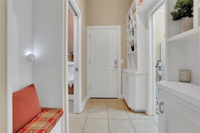 interior space featuring light tile patterned floors and baseboards