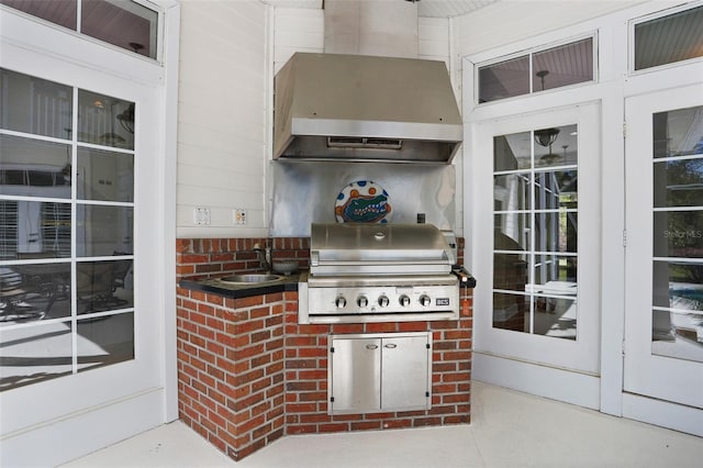 view of patio featuring a grill, exterior kitchen, and a sink