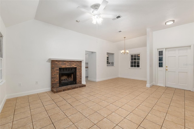 unfurnished living room featuring ceiling fan, a chandelier, a fireplace, lofted ceiling, and light tile patterned floors