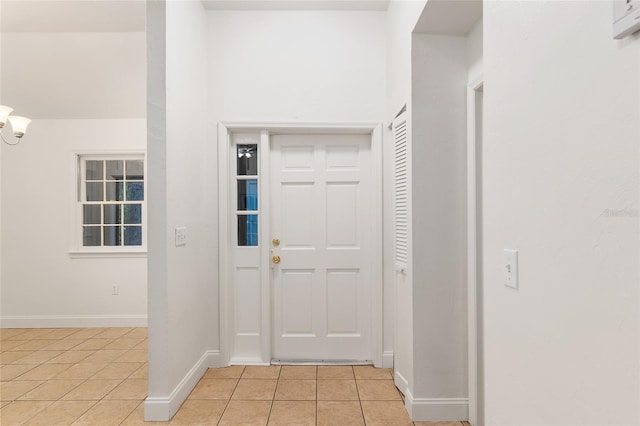 entrance foyer with light tile patterned floors and baseboards