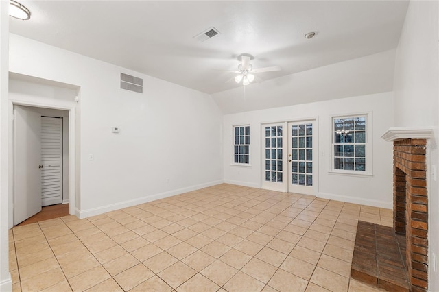 unfurnished living room featuring a ceiling fan, lofted ceiling, baseboards, and light tile patterned flooring