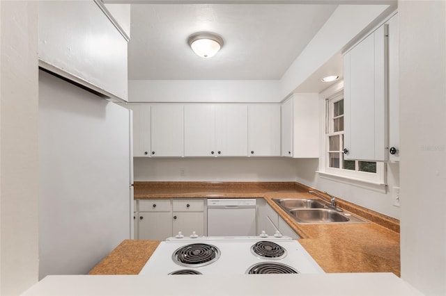 kitchen featuring a sink, white appliances, and white cabinets