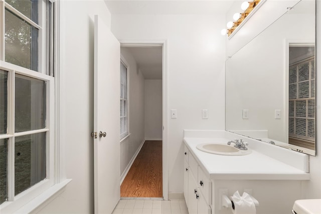 bathroom featuring vanity, toilet, and baseboards