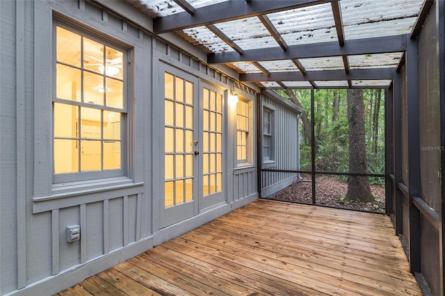 unfurnished sunroom featuring french doors and beam ceiling