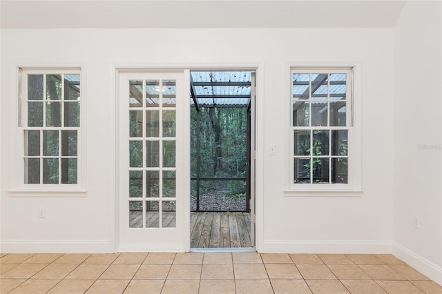 entryway featuring baseboards and light tile patterned flooring