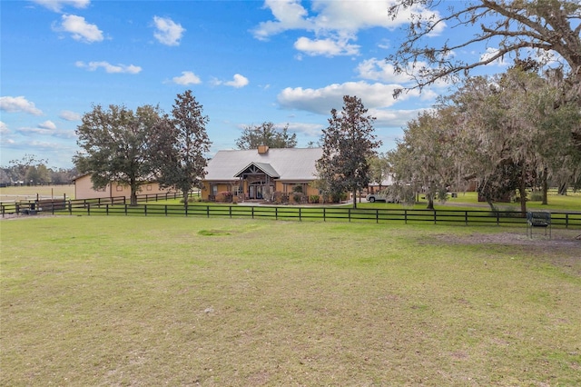 view of yard featuring fence and a rural view