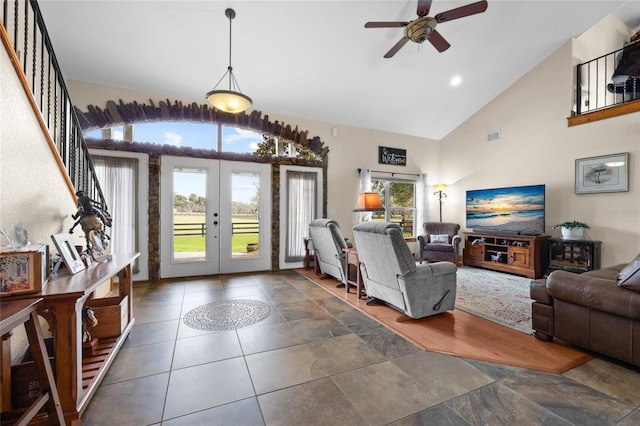 living area featuring stairs, french doors, high vaulted ceiling, visible vents, and ceiling fan