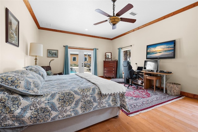 bedroom featuring crown molding, french doors, access to outside, visible vents, and wood finished floors