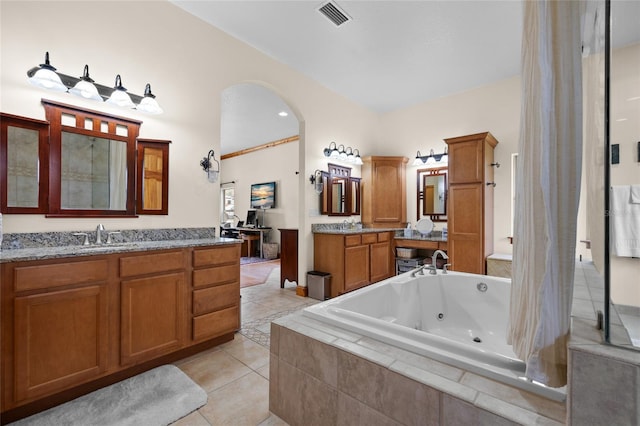 bathroom featuring visible vents, two vanities, a sink, a jetted tub, and tile patterned flooring