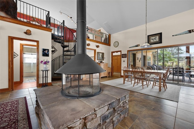 dining area featuring plenty of natural light, baseboards, and high vaulted ceiling