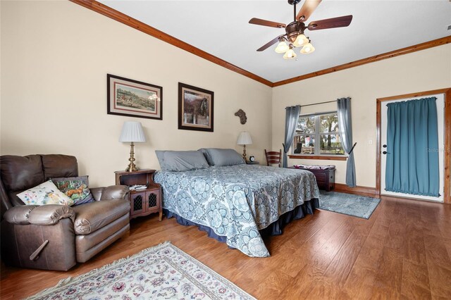 bedroom with ornamental molding, wood finished floors, and ceiling fan