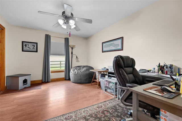 office space featuring baseboards, ceiling fan, and wood finished floors
