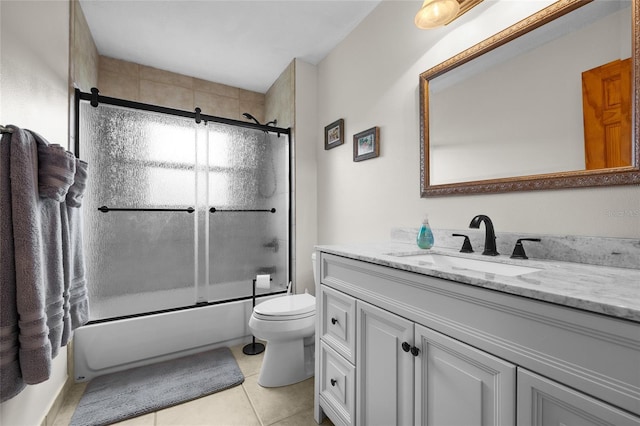 full bathroom with enclosed tub / shower combo, toilet, tile patterned flooring, and vanity