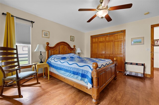 bedroom featuring a closet, baseboards, ceiling fan, and wood finished floors