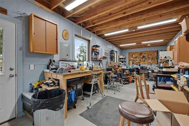 misc room with a workshop area and concrete flooring