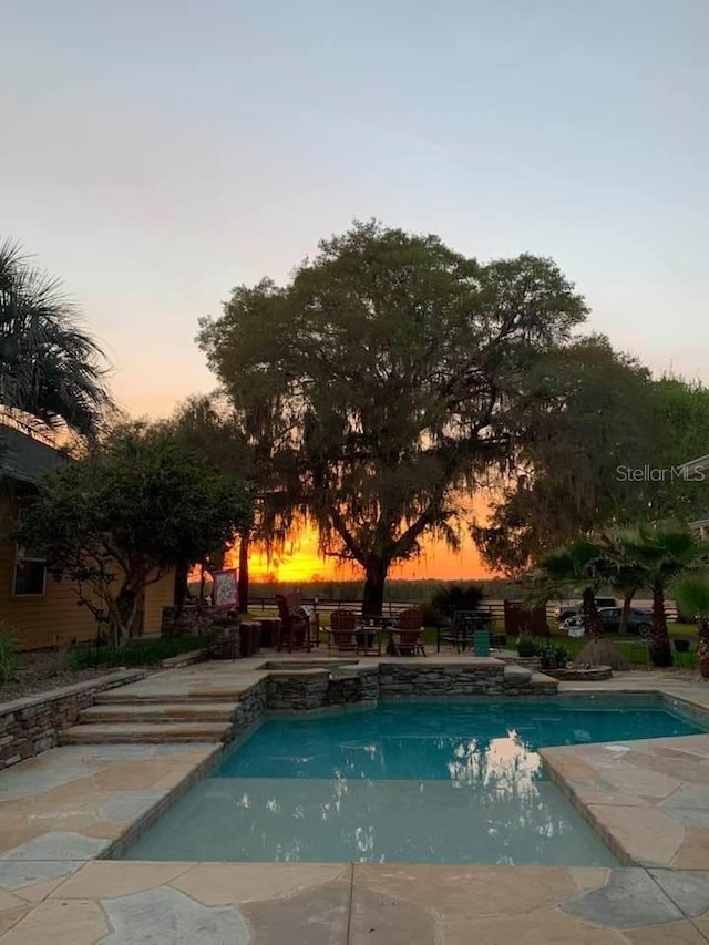 view of swimming pool with a pool with connected hot tub and a patio area