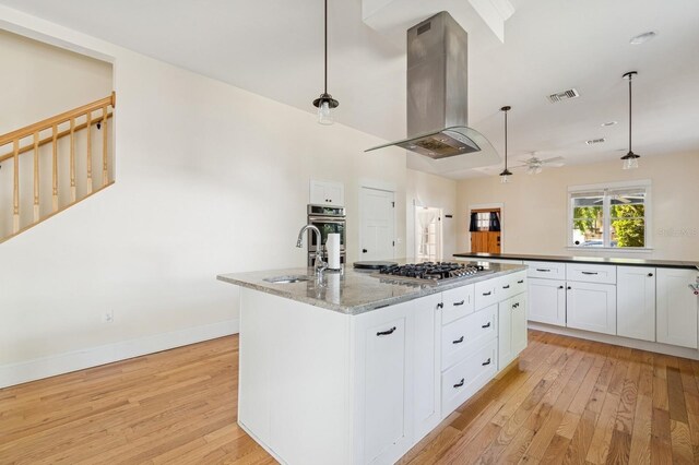 620 NE 6th Ave, Gainesville, FL 32601 - kitchen featuring visible vents, a sink, light wood-style floors, and island range hood