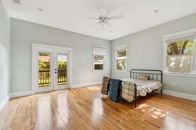 620 NE 6th Ave, Gainesville, FL 32601 - bedroom featuring wood-type flooring, baseboards, access to exterior, and french doors