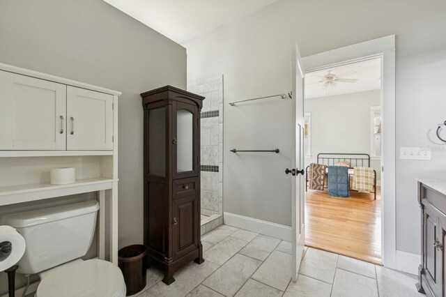 620 NE 6th Ave, Gainesville, FL 32601 - full bathroom with baseboards, toilet, and tiled shower