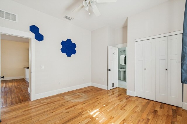 620 NE 6th Ave, Gainesville, FL 32601 - unfurnished bedroom with a sink, baseboards, light wood-type flooring, and visible vents