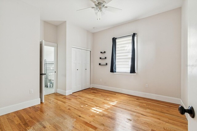 620 NE 6th Ave, Gainesville, FL 32601 - unfurnished bedroom featuring light wood-style floors, baseboards, a ceiling fan, and a closet