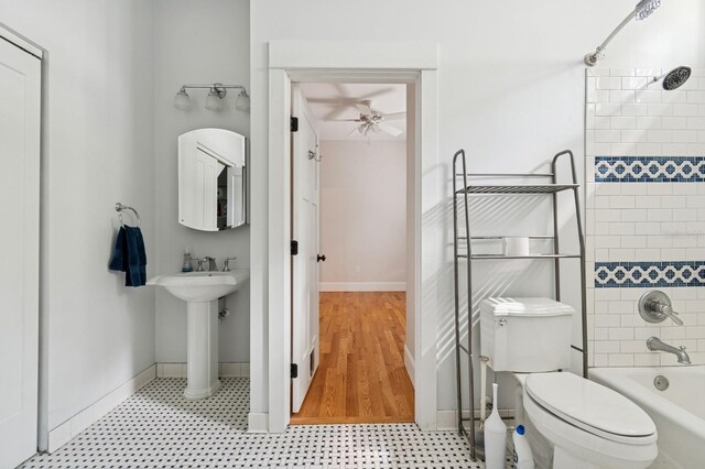 620 NE 6th Ave, Gainesville, FL 32601 - full bathroom with a ceiling fan, a sink, toilet, baseboards, and  shower combination