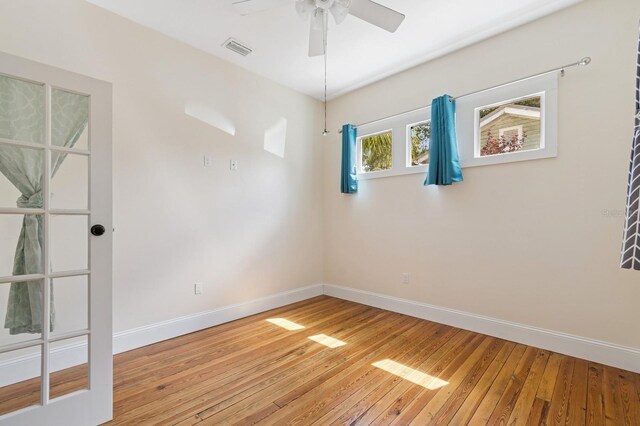 620 NE 6th Ave, Gainesville, FL 32601 - unfurnished room featuring light wood-style floors, baseboards, a ceiling fan, and visible vents