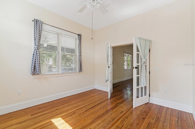 620 NE 6th Ave, Gainesville, FL 32601 - unfurnished room featuring a ceiling fan, baseboards, and hardwood / wood-style floors