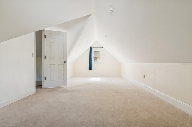 620 NE 6th Ave, Gainesville, FL 32601 - additional living space with baseboards, carpet flooring, and lofted ceiling