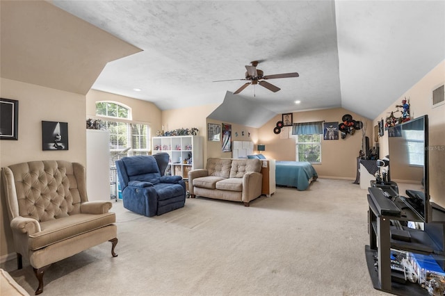 living area with ceiling fan, light carpet, visible vents, and lofted ceiling