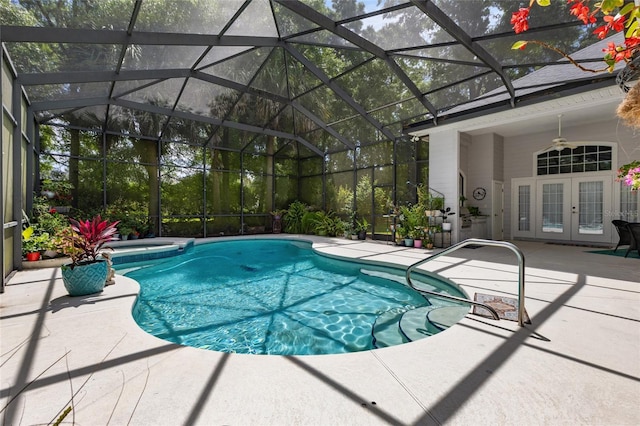 pool featuring a patio, an in ground hot tub, a lanai, and french doors