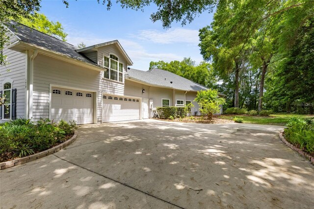 view of home's exterior featuring a garage and driveway