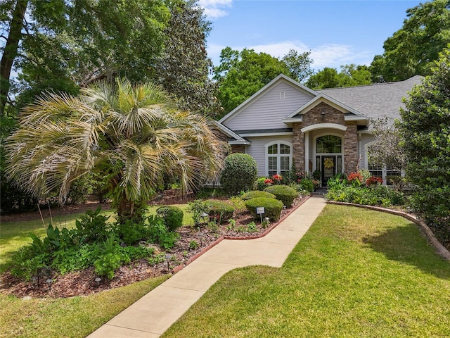 view of front of house featuring a front lawn and stone siding