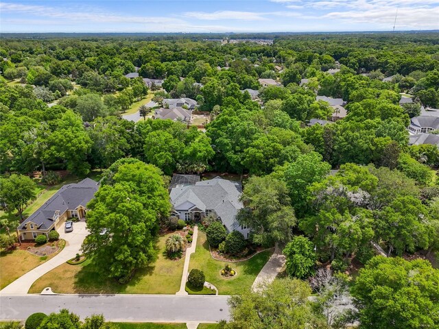 birds eye view of property with a forest view and a residential view
