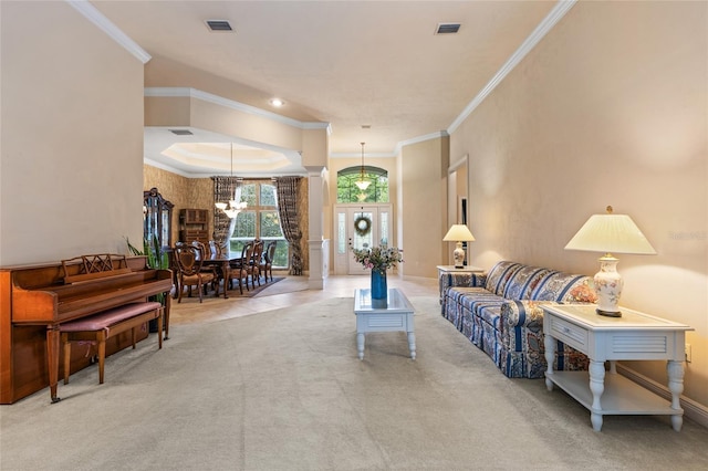 carpeted living room with crown molding, a chandelier, and visible vents