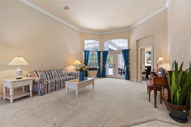 carpeted living area with crown molding, baseboards, visible vents, and french doors