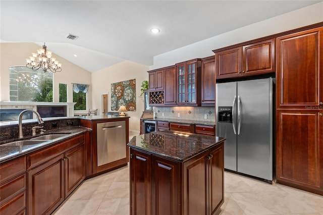 kitchen featuring a notable chandelier, a sink, stainless steel appliances, tasteful backsplash, and visible vents