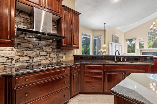 kitchen with ventilation hood, a sink, dark stone countertops, backsplash, and vaulted ceiling